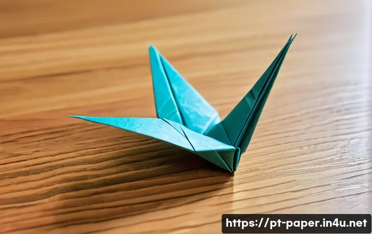 종이 아트 스타일 - A detailed close-up image of a beginner’s origami project on a wooden desk, showing thin, colorful o...